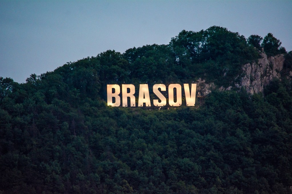 A view of the famous Brasov sign, located in the heart of the historic city. Take in the lively atmosphere of Brasov and enjoy this iconic landmark, which is a popular spot for photos.