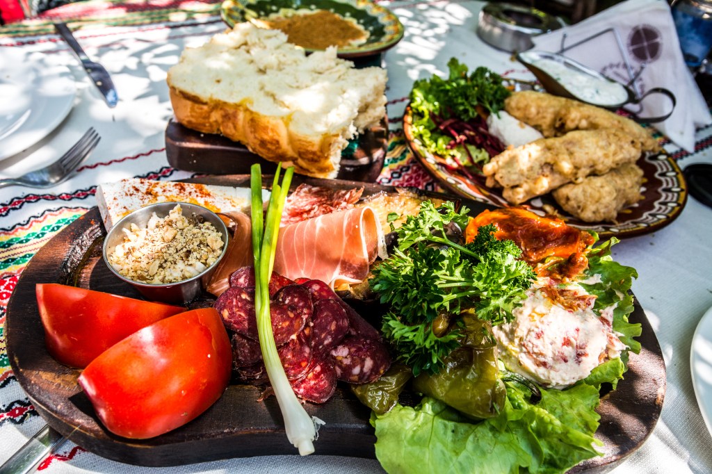 Experience the delicious Bulgarian cuisine at Manastriska Magernitsa restaurant - traditional dishes enjoyed by Brett and Bianca