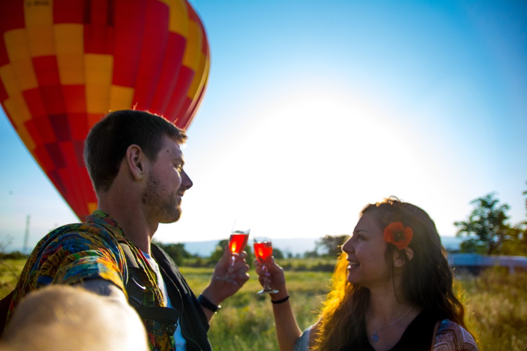 Bianca and Brett celebrating their hot air balloon experience with a glass of champagne in Cappadocia, Turkey - a once-in-a-lifetime adventure with stunning views and unforgettable memories.