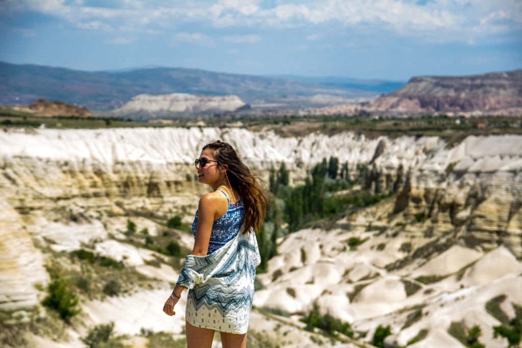 Bianca enjoying the stunning view of White Valley from above in Cappadocia, Turkey - a breathtaking and picturesque landscape with unique geological formations.