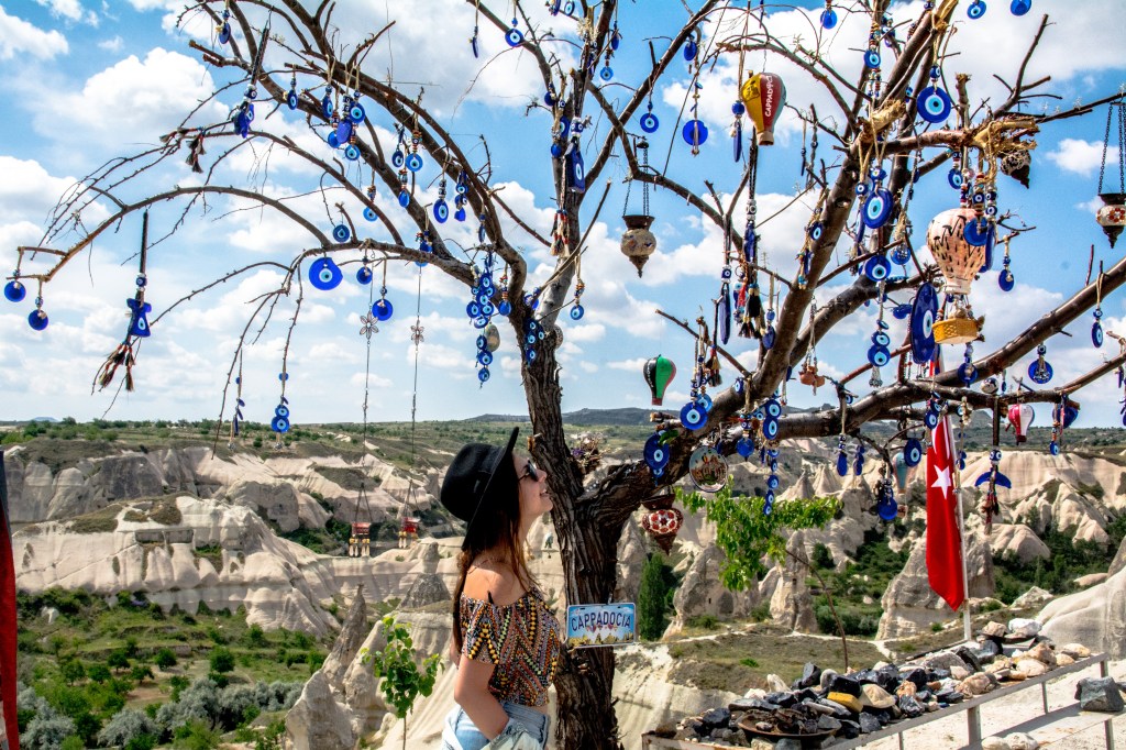Bianca admiring the Evil Eye Tree - a traditional symbol of protection and good luck in Turkish culture, located in the beautiful region of Cappadocia, Turkey.