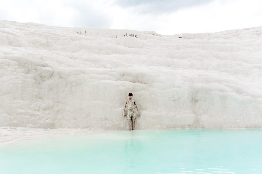 Brett standing on white terraced pools in Pamukkale, Turkey.