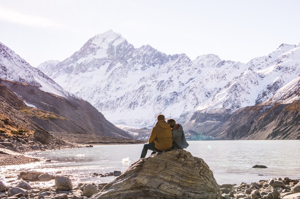 Hooker Valley track - Brett and Bianca admiring snow capped mountains on family hike.