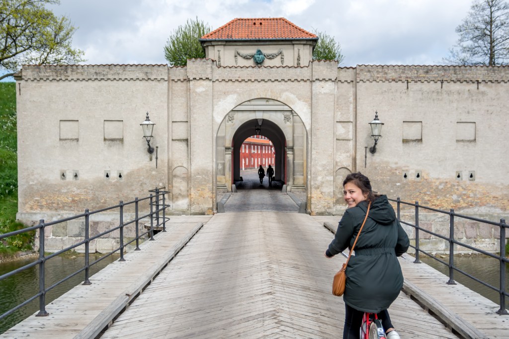 View of a cyclist exploring Kastellet in Copenhagen, Denmark - a beautiful and historic landmark perfect for a bike ride. Experience the city's rich cultural heritage on this unforgettable adventure.