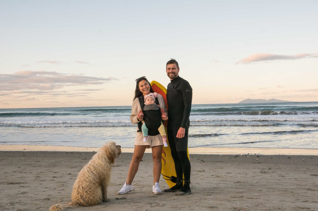 Brett, Bianca, their daughter, and dog posing for a family photo in Waihi - a perfect New Zealand destination for family and pet-friendly travel.