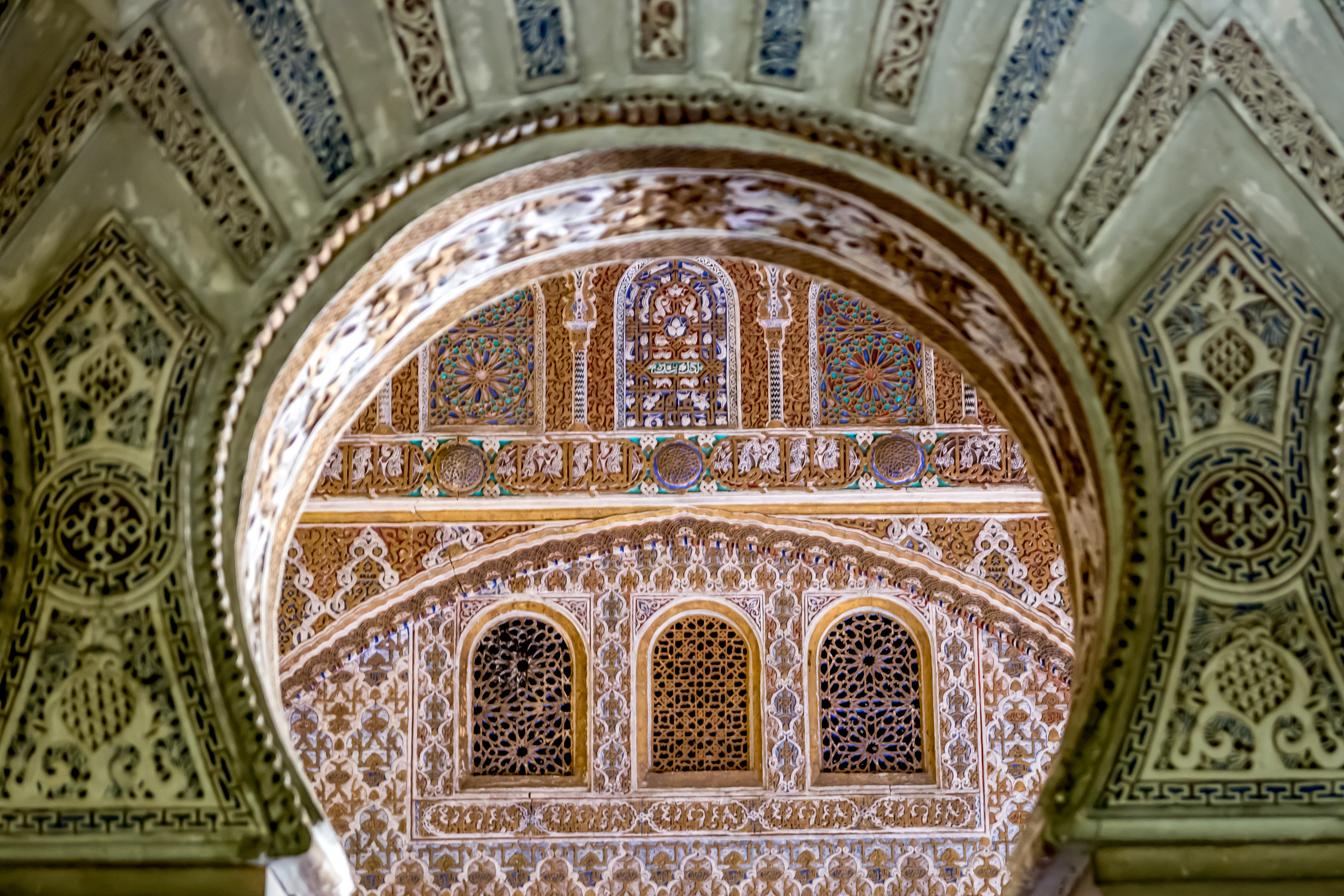 Real Alcazar in Seville, Spain, showcasing stunning examples of Islamic and Mudéjar architecture, intricate details, and breathtaking mosaic tiles.