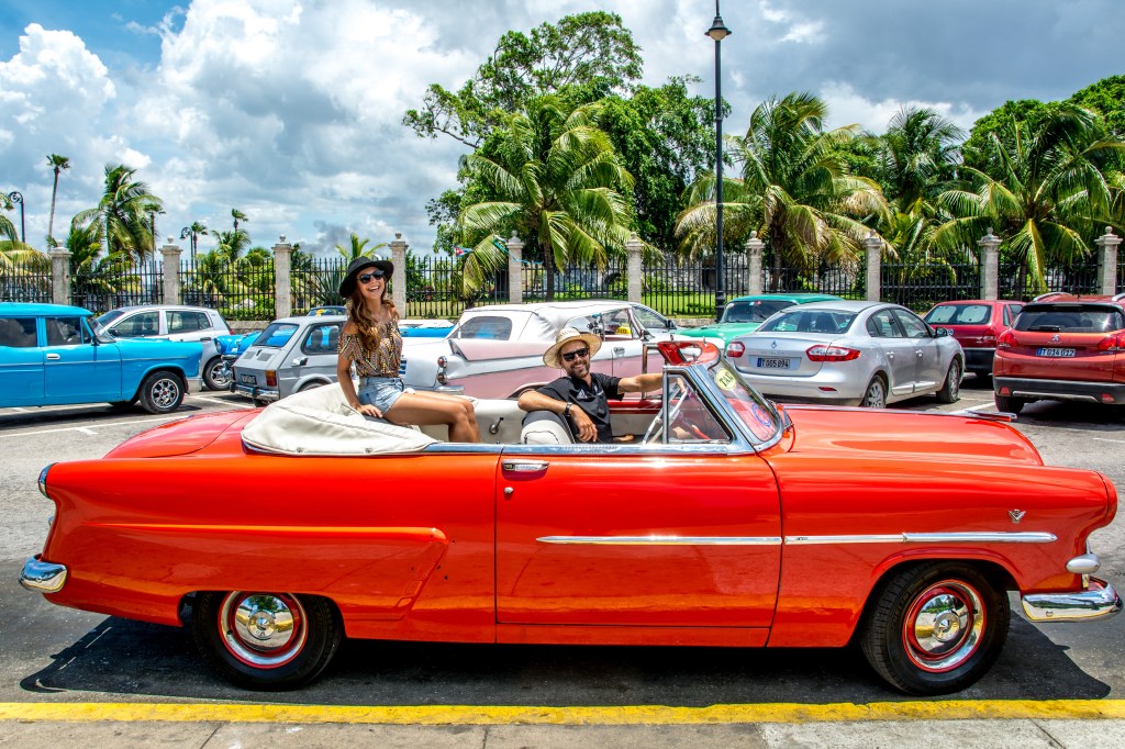 Bianca and Brett enjoying a classic car ride in colorful Trinidad, Cuba.