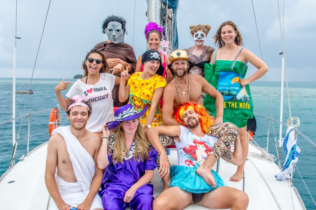 Joyful group participating in a lively costume party on our sailing adventure.