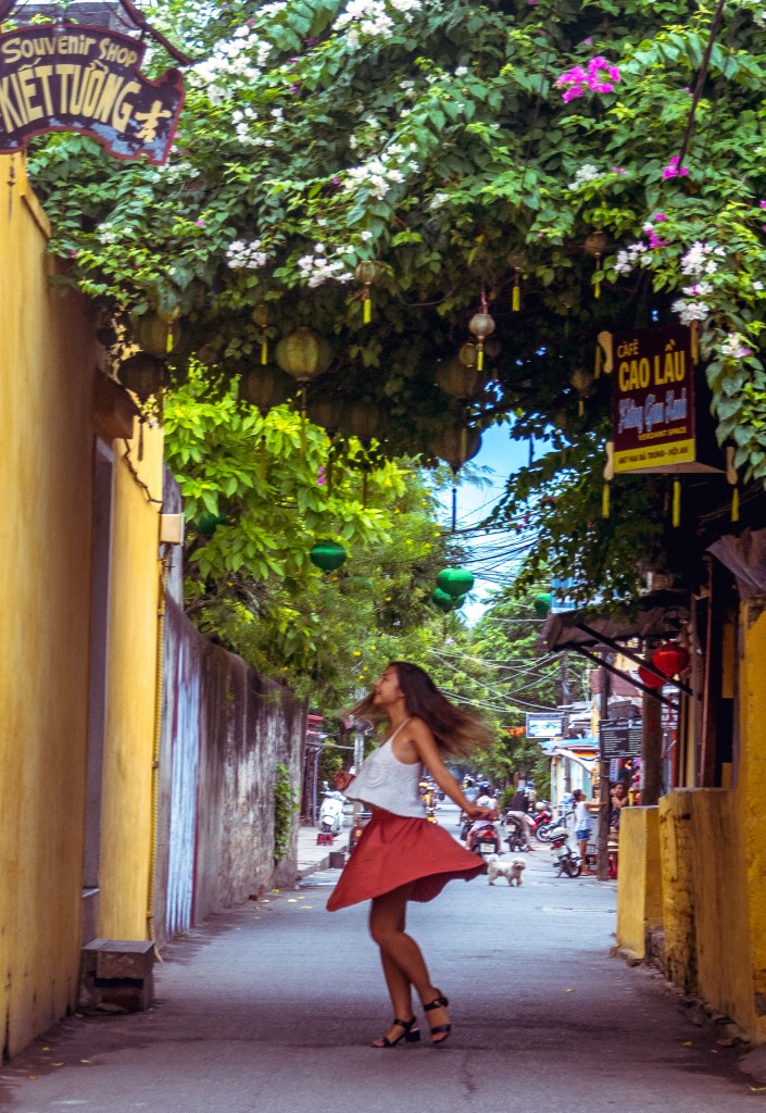 Bianca enjoying a joyful twirl in the charming streets of Hoi An.