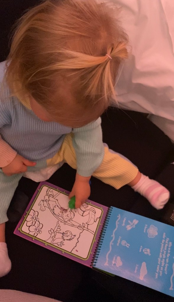 Toddler using Melissa and Doug Water Wow Books.