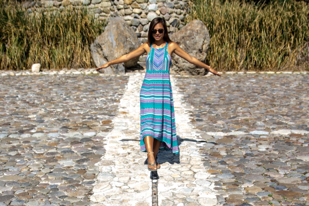 Bianca Balancing on the Equator Line in Quito, Ecuador' - Marvel at Bianca's feat as she balances along the Equator line in the historic city of Quito, Ecuador. Discover the unique and symbolic experience of straddling two hemispheres.