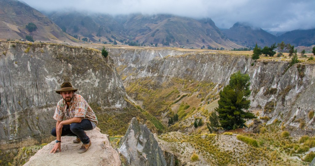 Brett Posing in an Ecuadorian Crater' - Capture the adventurous spirit as Brett strikes a pose within an Ecuadorian crater. Explore the natural beauty and wonder of this unique destination.