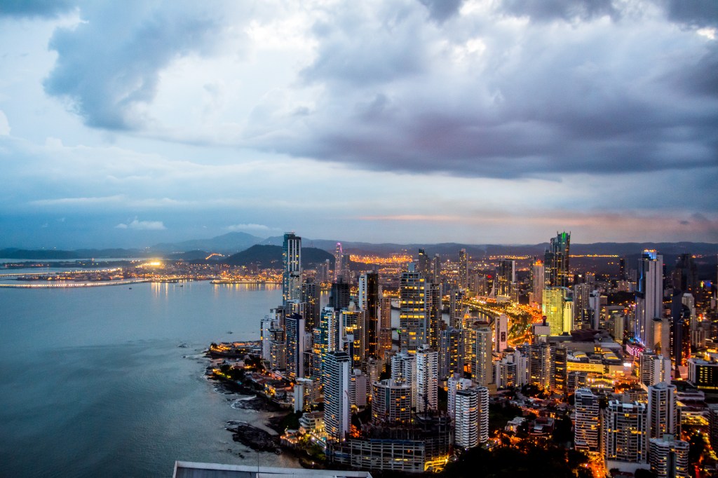City View from Trump Tower's Lookout Bar, A Sunset Spectacle' - Ascend to the top lookout bar of Trump Tower for a breathtaking city view that stretches into Old Town. Watch the setting sun paint the sky with fiery hues as it descends behind distant mountains.