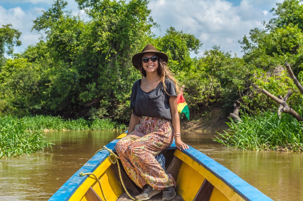 Image depicting Bianca awestruck while navigating the Amazon River by boat, showcasing the vastness and beauty of the Amazon rainforest, a remarkable travel experience.