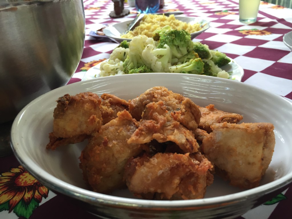 Image displaying a freshly caught Piranha from the Amazon River, skillfully prepared and served with a side of vegetables, showcasing the culinary experience of Amazonian cuisine.