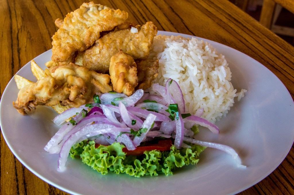 Image showcasing the delightful experience of savoring local Peruvian cuisine, highlighting traditional dishes and flavors.