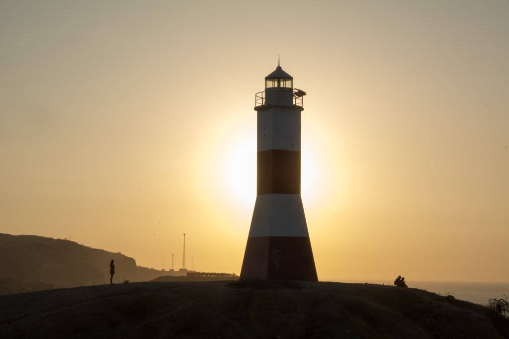 Image capturing the sunset view from the lighthouse in Mancora, showcasing the picturesque coastal beauty and serene ambiance of the Peruvian beach town.
