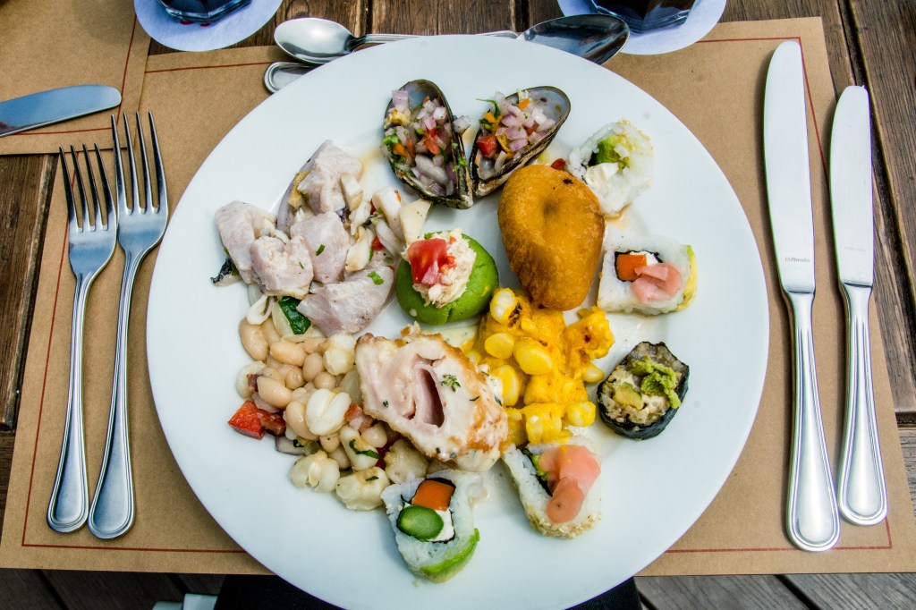 Image showcasing Mangos restaurant on the Malecon in Miraflores, Lima, a top spot for buffet lunches and stunning sunset views over the water, offering a diverse selection of Peruvian cuisine.