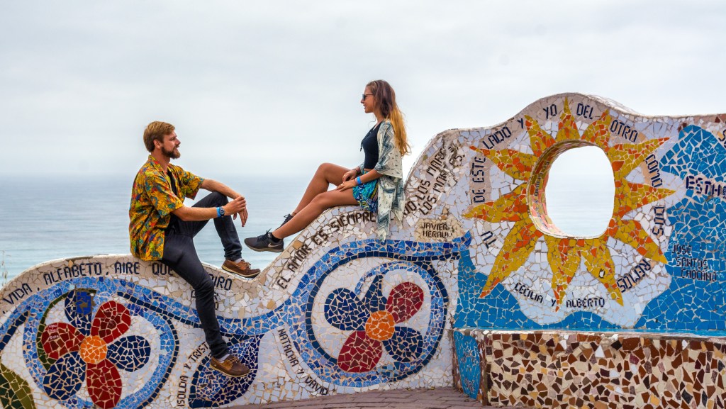 Image capturing Bianca and Brett enjoying a peaceful moment on the boardwalk (Malecon) in Miraflores, showcasing the relaxed ambiance and scenic views in Lima, Peru.