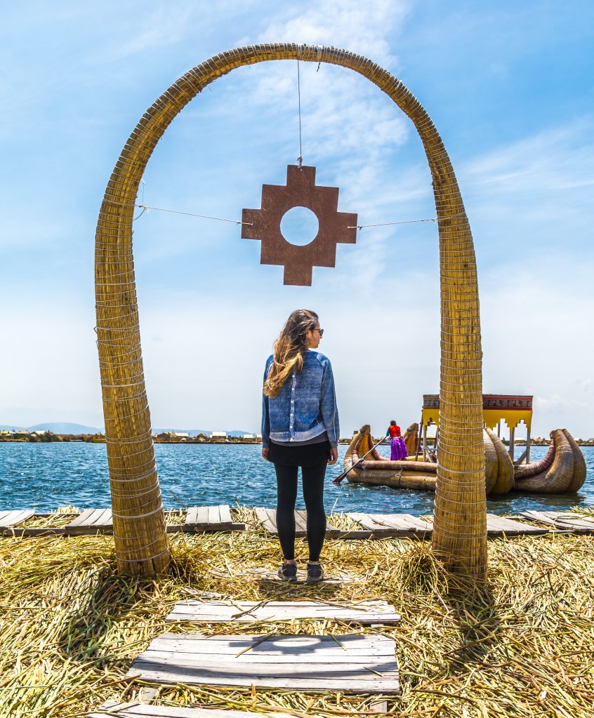 Image capturing Bianca admiring Uros, an island constructed entirely from reeds, showcasing the unique and eco-friendly craftsmanship on Lake Titicaca in Bolivia.