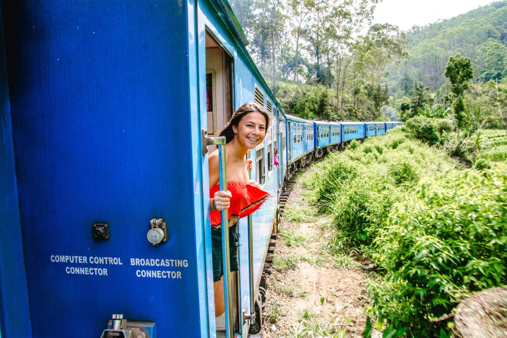 Image showcasing the scenic train ride from Ella to Kandy, Sri Lanka, offering picturesque views of mountains and tea plantations.