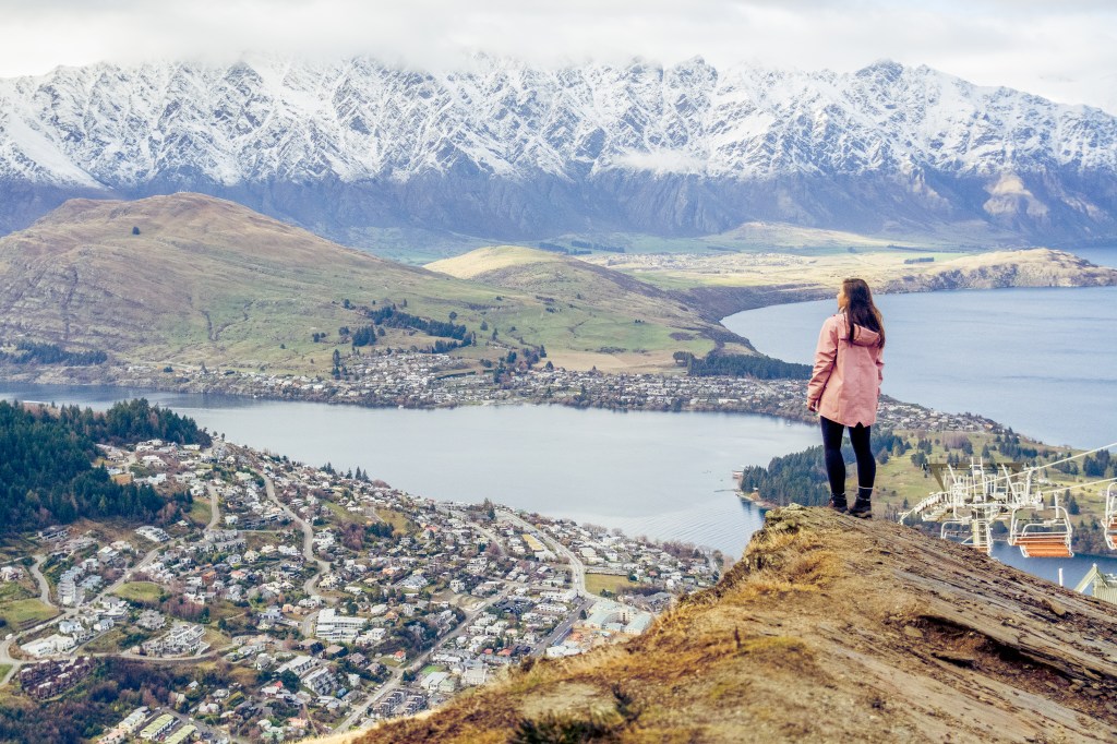 Bianca captivated by epic views atop Queenstown Hill. Immerse yourself in the breathtaking panorama of Queenstown from this iconic vantage point.