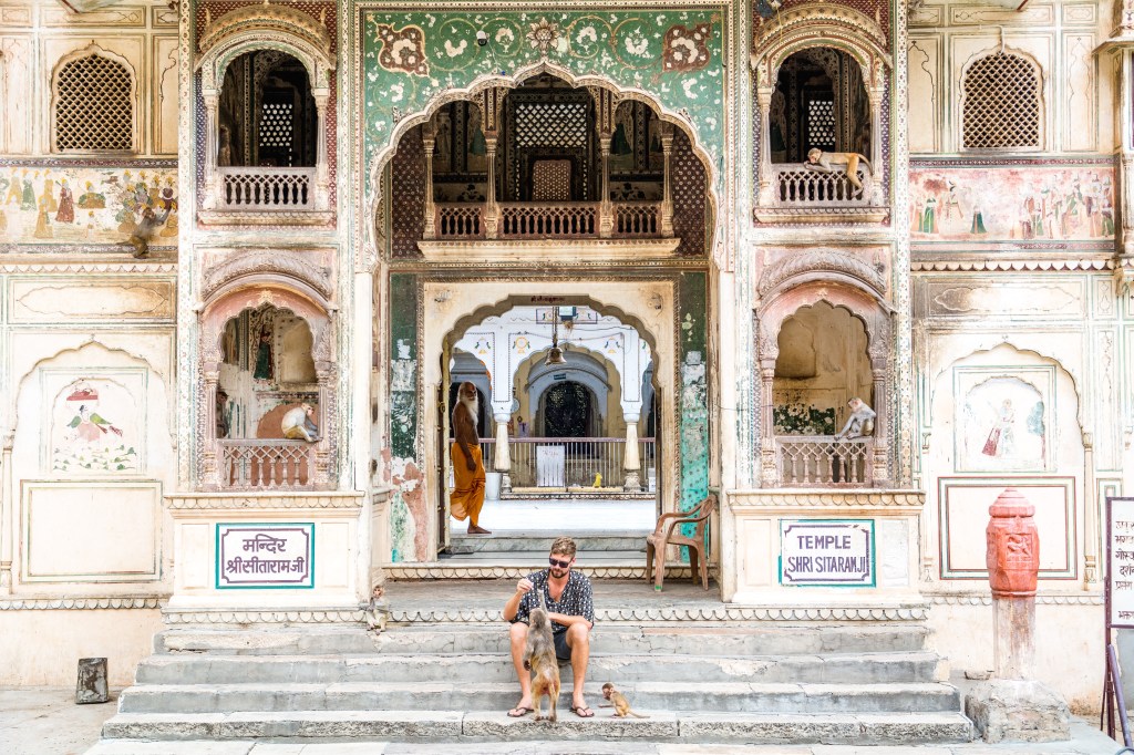 Brett sharing snacks with hosts at Galta Monkey Temple