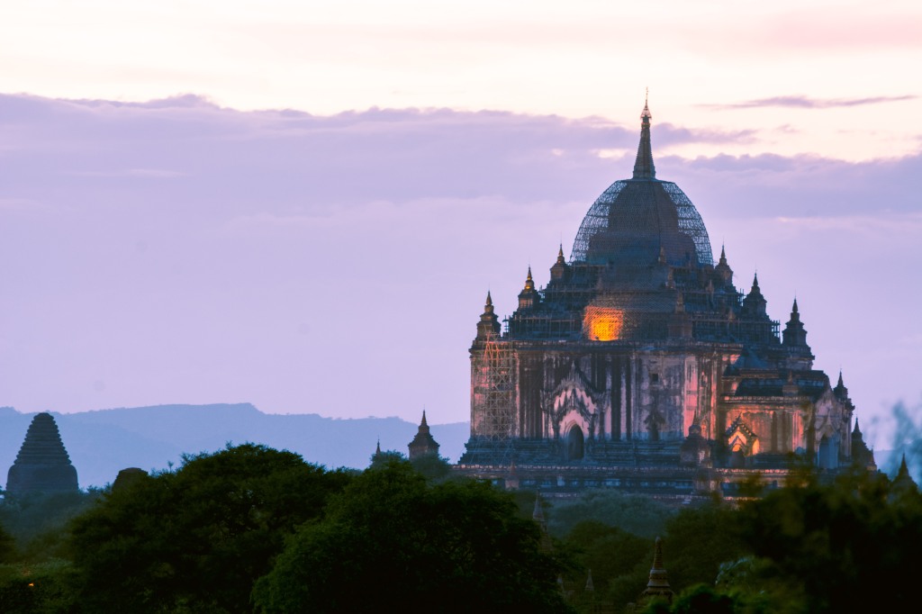 Breathtaking Dusk Glow - Main Pagoda Illuminated in the Heart of Bagan | Witness the enchantment as the main pagoda in Bagan comes to life in the soft glow of dusk. A mesmerizing scene capturing the timeless beauty of Myanmar's cultural heritage.