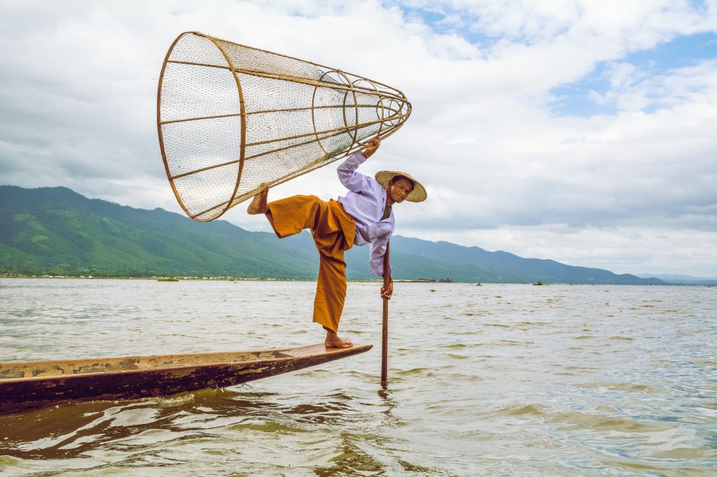 Inle Lake's Unique Fishing Artistry - Balancing Wonders in Myanmar's Waters | Witness the extraordinary art of fishing on Inle Lake, where skillful balance defines the catch. A mesmerizing display of tradition and harmony with nature.