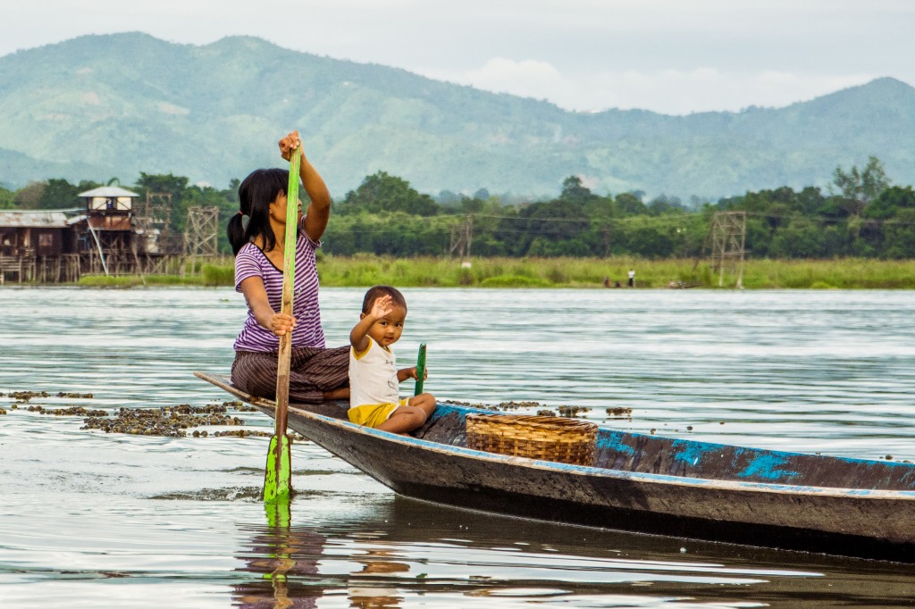 Serene Family Bonding - Mother and Son Enjoying a Boat Ride on Inle Lake | Experience the tranquility of family moments as a mother and son share a boat ride on the serene waters of Inle Lake. A heartwarming adventure in Myanmar.