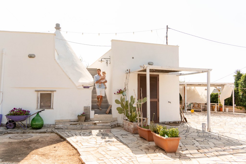 Image of the ancient stone house 'The Three Flowers' Airbnb in Puglia, Italy, a charming and historic accommodation option surrounded by the picturesque countryside of the region, offering a unique and authentic Italian experience.