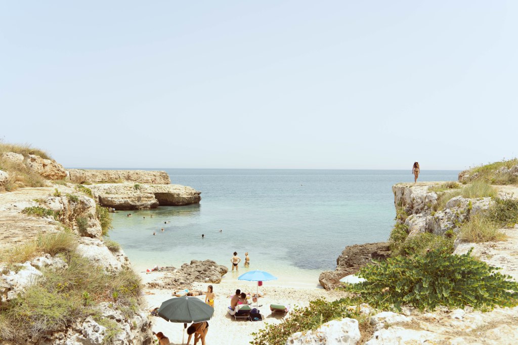 Image of admiring the coastline between Monopoli and Capitola, a stunning stretch of the Adriatic coast in Puglia, Italy, characterized by its rugged cliffs, crystal-clear waters, and charming coastal towns.