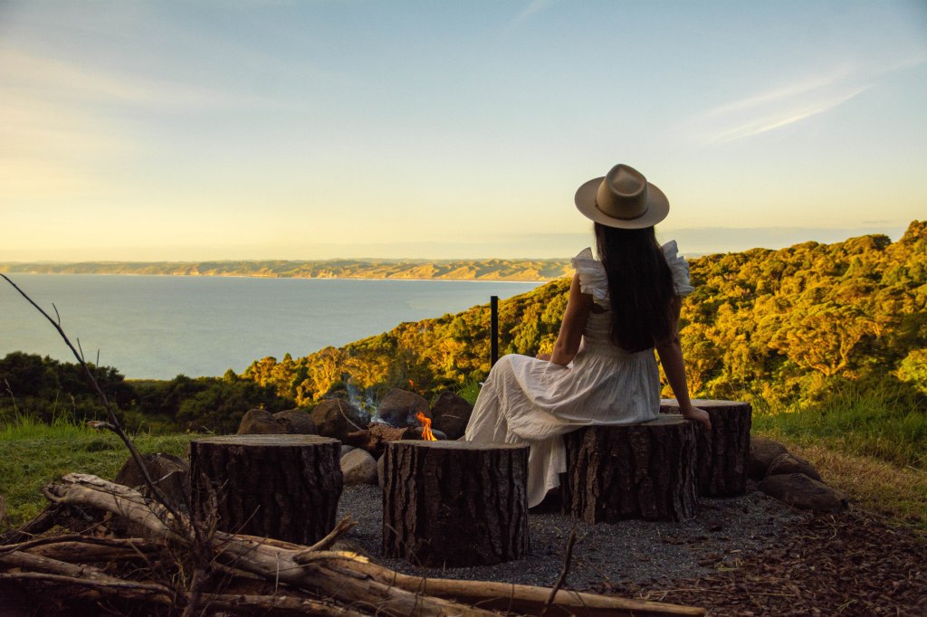 Cozy fire pit at a stunning scenic spot in Raglan, New Zealand - perfect for relaxing by the ocean at sunset.