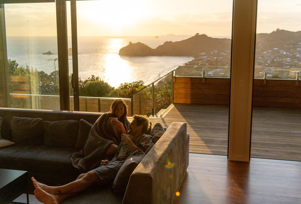 Morning coffee at Hahei Heights accommodation with scenic views, New Zealand travel experience.