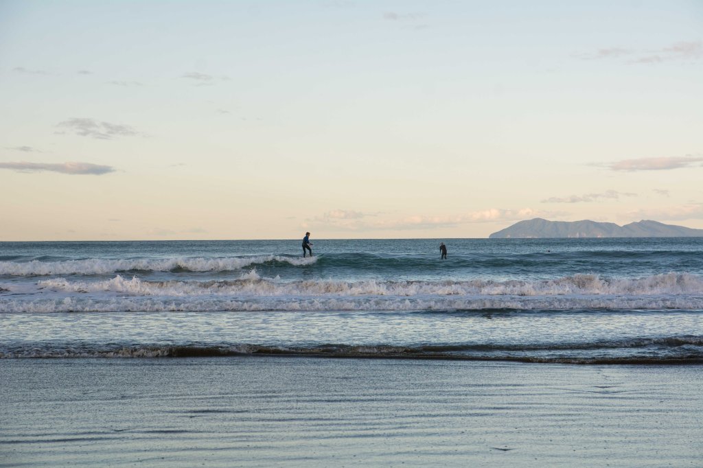 Brett surfing at Waihi Beach, New Zealand, surfing action shot, ocean waves