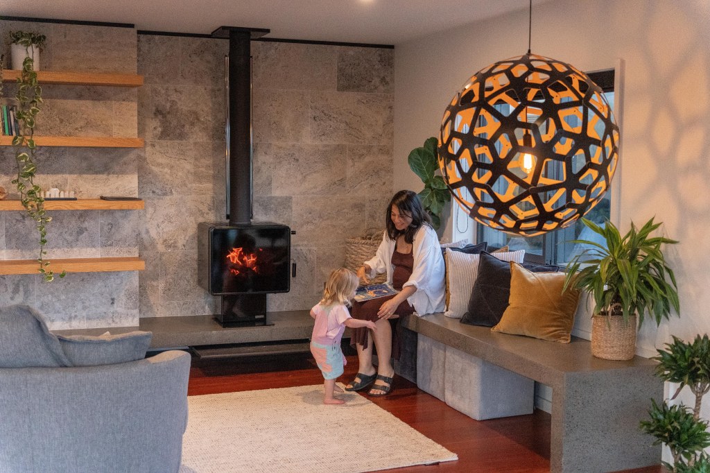 Stunning fireplace at Hahei Heights luxury accommodation, keeping warm during a cozy New Zealand getaway.