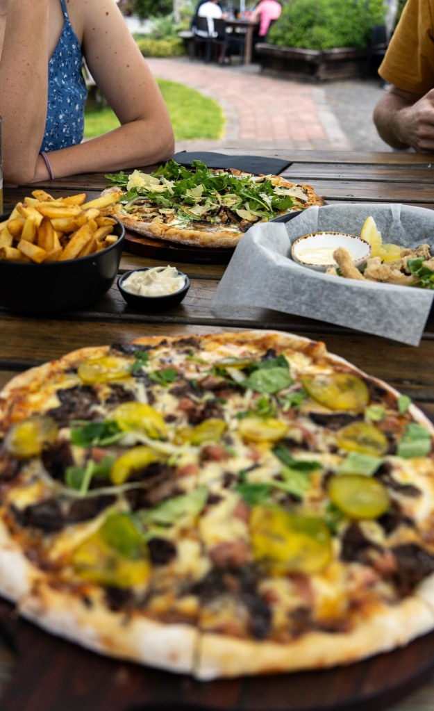 Delicious pizzas served at The Hive in Purangi, Coromandel – a must-visit dining spot in New Zealand.