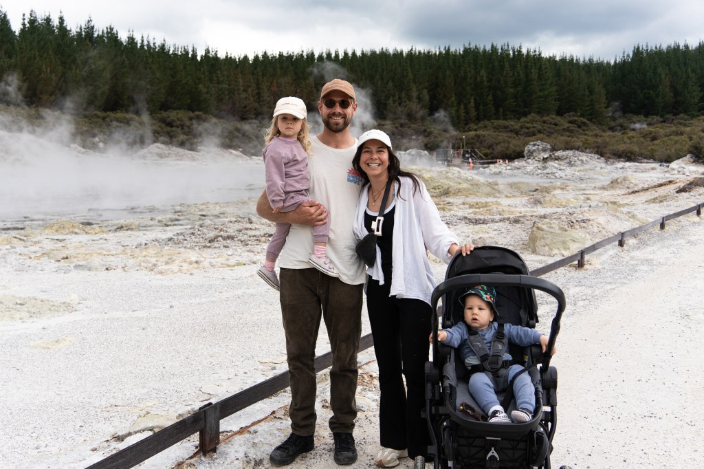 Family exploring geothermal activity at Hell’s Gate in Rotorua, New Zealand — steamy walk past mud pools, hot springs, and volcanic landscapes.
