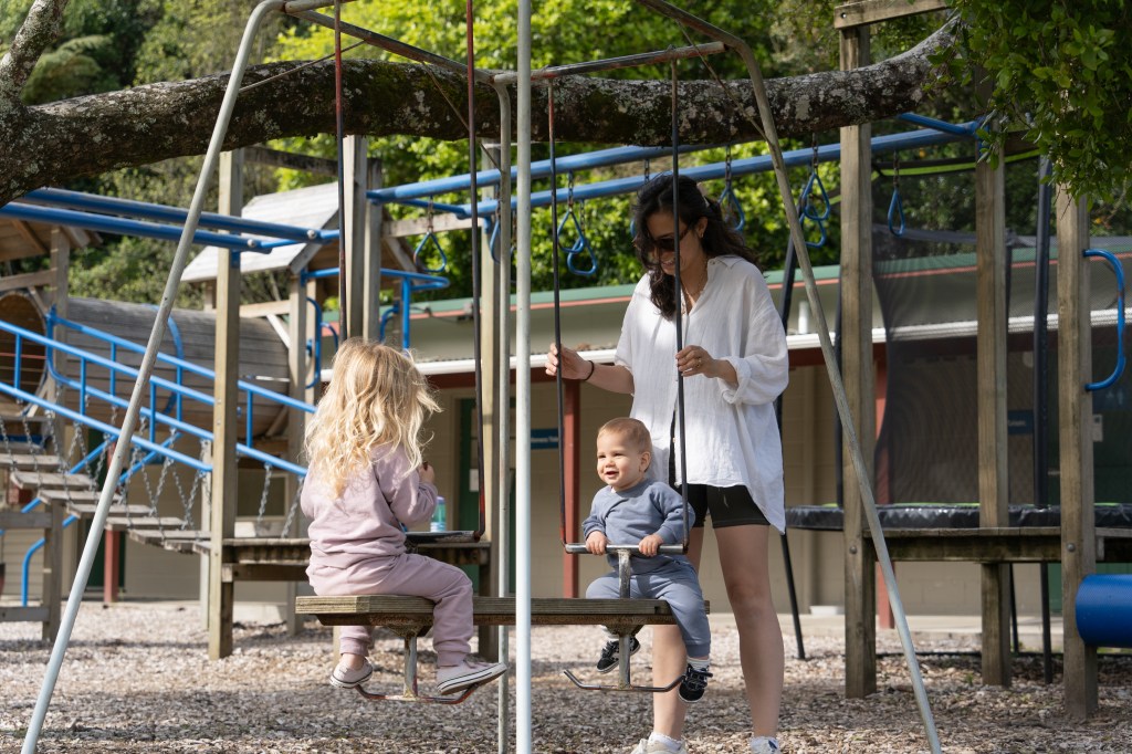 Kids playing and having fun at the playground at Blue Lake TOP 10 Holiday Park in Rotorua, New Zealand — family-friendly holiday accommodation with great facilities.