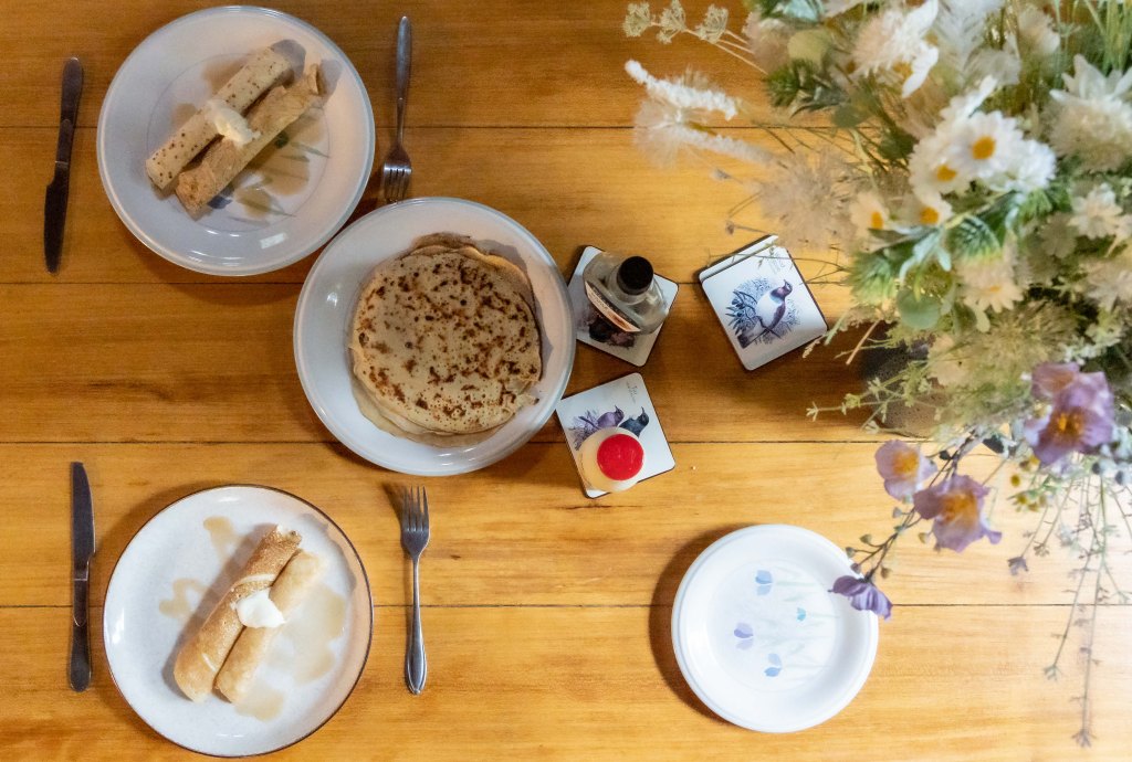 Homemade breakfast served at Wainui Seaside Glamping accommodation in New Zealand, featuring fresh local ingredients in a cozy coastal setting.