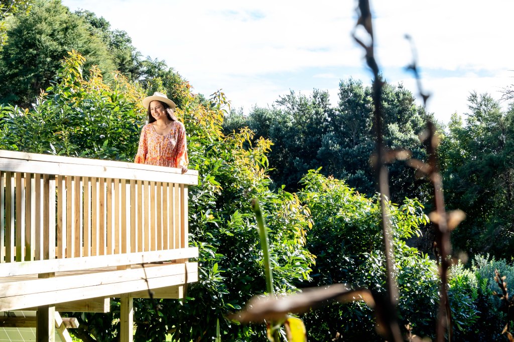 Bianca relaxing and enjoying her stay at Wainui Seaside Glamping, soaking in the coastal views and peaceful atmosphere in New Zealand.