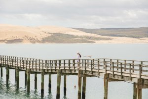 Bianca enjoying a peaceful stroll along the historic Opononi Wharf, taking in the coastal scenery in Northland, New Zealand.