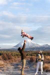 Brett and Florence enjoying a family long weekend at Mount Ruapehu with a stunning snow-covered mountain backdrop, Pukawa Bay New Zealand travel blog