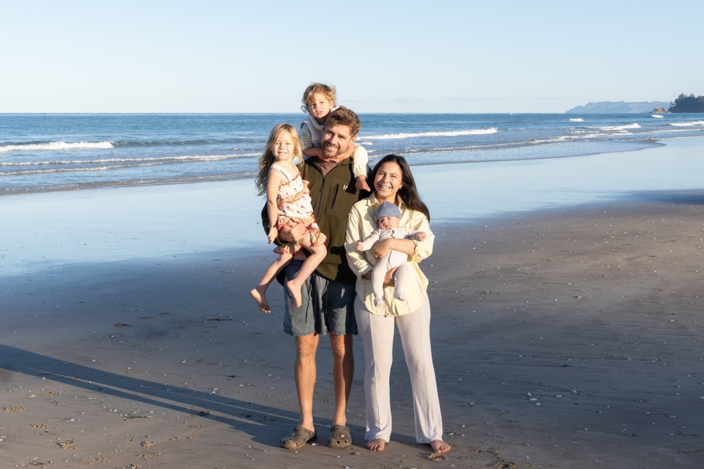 Bianca and Brett with their children at the beach, enjoying a relaxed family moment together by the ocean