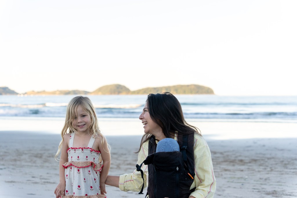 Bianca carrying one of her babies in the Beco Gemini Cool Mesh Baby Carrier V1, demonstrating a breathable and supportive babywearing setup.