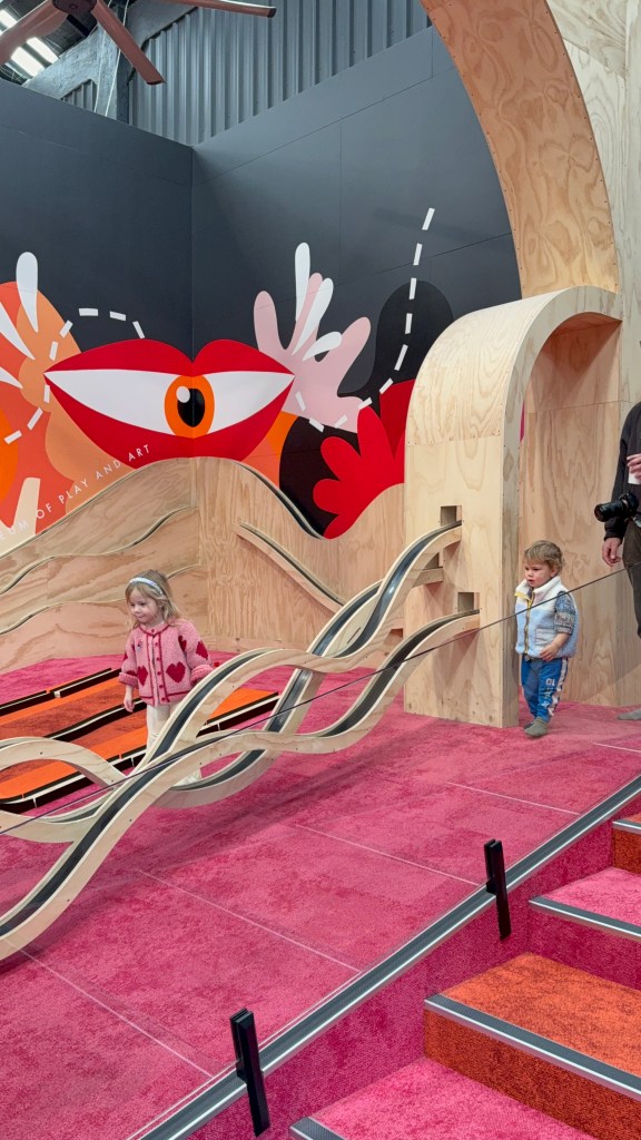 Children playing with car race tracks at MOPA (Museum of Play and Art).
