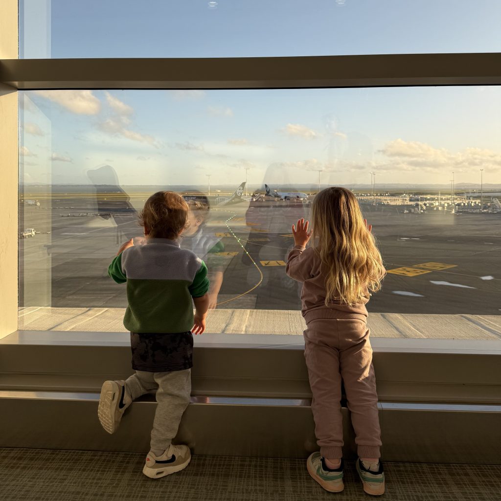 George and Florence watching planes and getting excited for their upcoming trip.