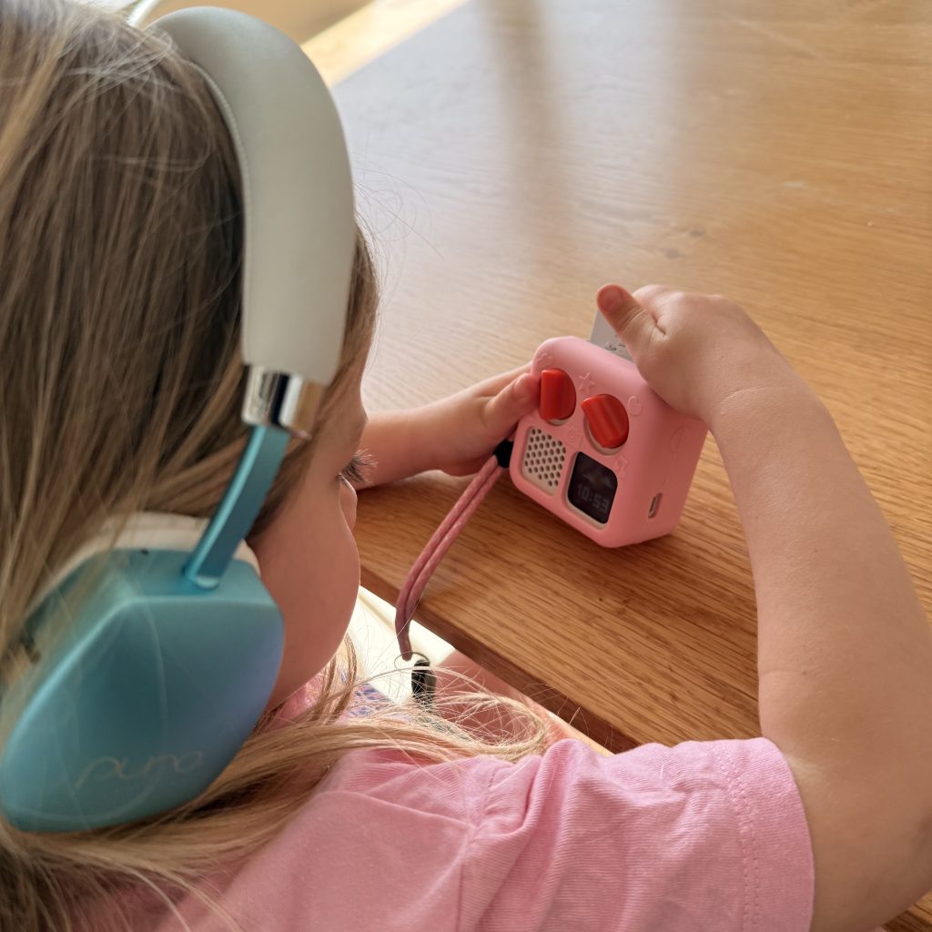 Florence enjoying her Mini Yoto Player while listening to stories and audio.