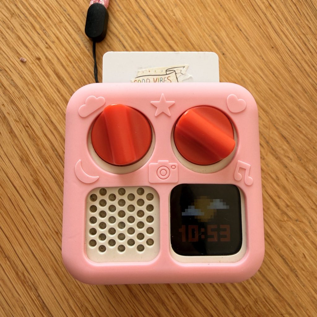 Mini Yoto Player, a compact audio player for kids that is ideal for travel.